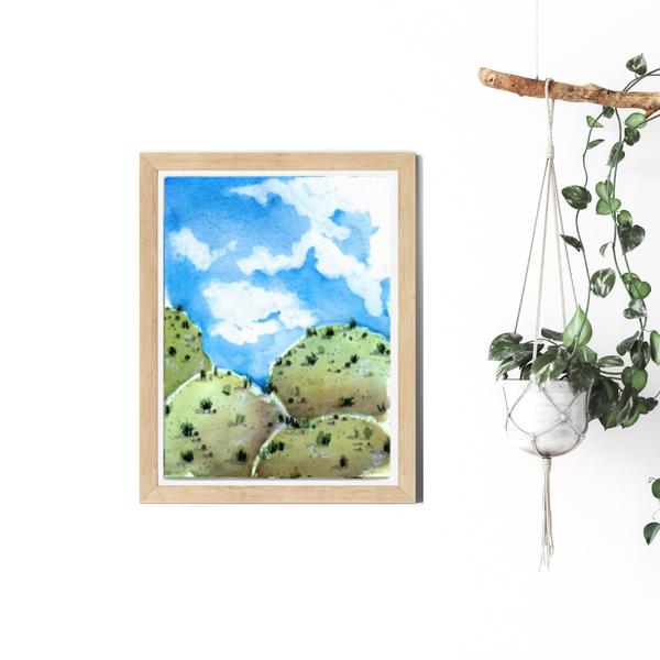 Wall art, watercolor painting, home decor, travel art, home decor gift, visual art, fine art, timeless, watercolor illustration, desert fantasy art, gifts for travel lovers, children living room, travel lover, graphic art, mountain illustration, stylized, places to visit in the world, magical realism, white ink on watercolor, American southwest, Sedona, Arizona, uplifting illustration, blue sky, blue and green landscape, grassy hills, desert hills painting, auspicious gifts for housewarming.