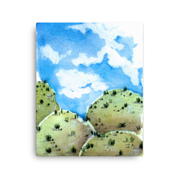 20 by 16 inches blue sky stylized American Southwest blue and green Landscape watercolor canvas print. Visual art piece with bold, ethereal colors against a white wall.  Print of a desert hill painting. Great for minimalist home decor. Exudes magical realism and playfulness. Emerald green grassy hills.